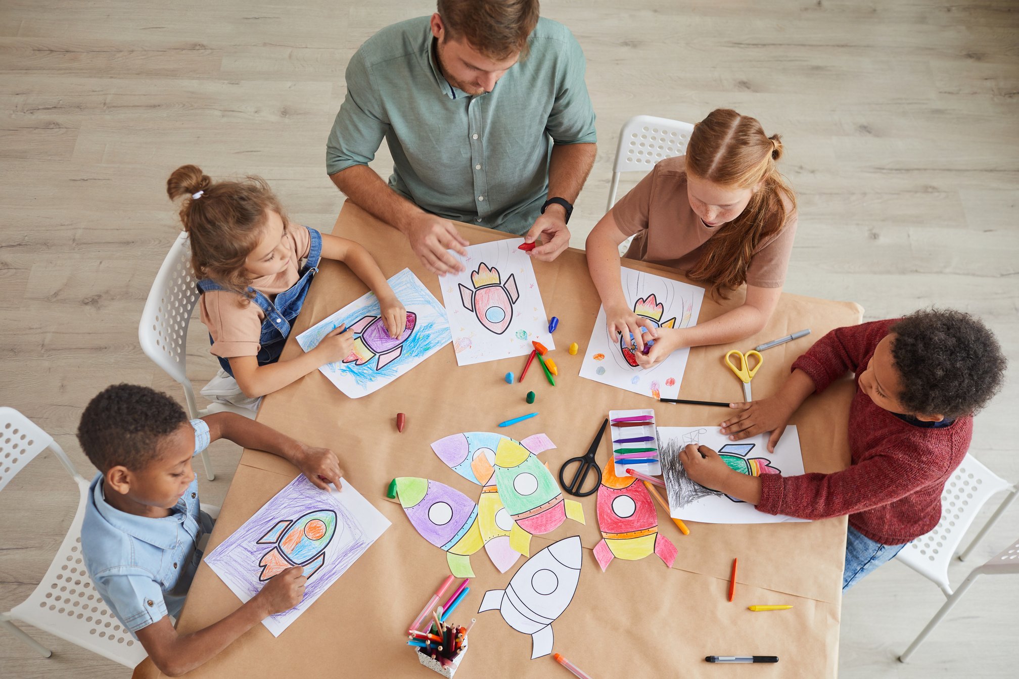 Kids Drawing Space Rockets Above View